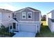 Two-story house with gray siding, attached garage, and landscaping at 1534 Marksman Rd, Eagle Lake, FL 33839