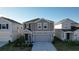 Two-story house with gray siding, a gray garage door, and landscaping at 1534 Marksman Rd, Eagle Lake, FL 33839