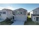 Two-story house with gray siding, a gray garage door, and landscaping at 1534 Marksman Rd, Eagle Lake, FL 33839