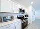 Modern kitchen with stainless steel appliances and white cabinets at 1534 Marksman Rd, Eagle Lake, FL 33839