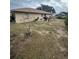 Backyard with a small tree and patchy grass at 160 Clay Cut Cir, Haines City, FL 33844