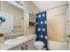 Bathroom with a shower and tub combination, gray vanity and matching cabinet at 160 Clay Cut Cir, Haines City, FL 33844