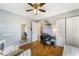 Comfortable bedroom featuring a stylish desk area and wood-look floors and a ceiling fan with lights at 160 Clay Cut Cir, Haines City, FL 33844