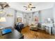 Bedroom with neutral walls, wood look floors, ceiling fan and a workspace with desk at 160 Clay Cut Cir, Haines City, FL 33844