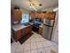 Modern kitchen with stainless steel appliances and wood cabinets at 160 Clay Cut Cir, Haines City, FL 33844