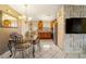 Cozy eat-in kitchen featuring stainless steel appliances, light cabinetry, and a decorative chandelier at 160 Clay Cut Cir, Haines City, FL 33844