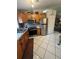 Modern kitchen with stainless steel appliances and wood cabinets at 160 Clay Cut Cir, Haines City, FL 33844