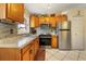 A well-lit kitchen featuring stainless steel appliances, granite counters, and white tile flooring at 160 Clay Cut Cir, Haines City, FL 33844