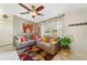 Inviting living room with neutral walls, large windows, ceiling fan, and comfortable seating at 160 Clay Cut Cir, Haines City, FL 33844