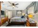 Cozy main bedroom with a ceiling fan, warm lighting, and wood furniture at 160 Clay Cut Cir, Haines City, FL 33844