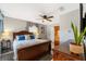 Bedroom with neutral walls, wood furniture, ceiling fan, and window with curtains at 160 Clay Cut Cir, Haines City, FL 33844