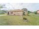 Side view of a well-maintained single-story home with a fenced yard and manicured lawn at 160 Clay Cut Cir, Haines City, FL 33844