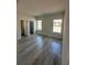 Well-lit bedroom with wood-look floors and a view of the neighborhood at 1617 Cumin Dr, Kissimmee, FL 34759