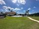 Community pool with a splash fountain and a clubhouse with a red tile roof at 1617 Cumin Dr, Kissimmee, FL 34759