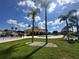 Community pool area with palm trees and a clubhouse under a bright, sunny sky at 1617 Cumin Dr, Kissimmee, FL 34759