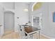 Small dining area with wooden table and chairs near a window at 1685 Waterview Loop, Haines City, FL 33844