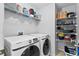 Laundry room with shelving and Samsung washer and dryer at 1685 Waterview Loop, Haines City, FL 33844