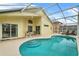 Relaxing kidney-shaped pool with screened enclosure and lounge chairs at 1685 Waterview Loop, Haines City, FL 33844