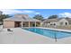 Community pool with lounge chairs and building at 1685 Waterview Loop, Haines City, FL 33844