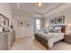 Serene bedroom featuring a wooden bed frame and neutral tones at 1694 Three Bars Rd, Kissimmee, FL 34744