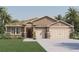 Beautiful one-story home with stone accents and a two-car garage at 1694 Three Bars Rd, Kissimmee, FL 34744