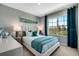 Bright bedroom with a comfortable bed, teal accents, and large window at 1741 Three Bars Rd, Kissimmee, FL 34744