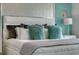 Main bedroom with white bed, fluffy pillows, and teal accents at 1741 Three Bars Rd, Kissimmee, FL 34744