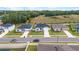 Aerial view of houses on a tree-lined street in a neighborhood at 1933 Burgundy Dr, Minneola, FL 34715