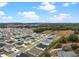 Aerial view of a neighborhood with various houses and landscape at 1933 Burgundy Dr, Minneola, FL 34715