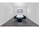 Simple dining room with dark hardwood floors and a glass table at 1933 Burgundy Dr, Minneola, FL 34715