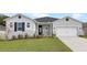 Two-story house with gray siding, black shutters, and a two-car garage at 1933 Burgundy Dr, Minneola, FL 34715