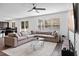 Open-concept living room with sectional sofa, view into kitchen at 1933 Burgundy Dr, Minneola, FL 34715