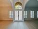 Light and airy foyer with double doors and hardwood floors at 240 Shady Oaks Cir, Lake Mary, FL 32746