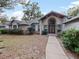 Front entry with walkway, double doors and brick columns at 240 Shady Oaks Cir, Lake Mary, FL 32746