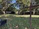 Large backyard with wooden cross and mature trees at 2429 S Elm Ave, Sanford, FL 32771