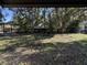 Large backyard with mature trees and seating area at 2429 S Elm Ave, Sanford, FL 32771