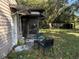 Small patio with seating area and partial enclosure, overlooking a grassy backyard at 2429 S Elm Ave, Sanford, FL 32771