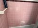 Pink tiled bathroom with shower/tub combo at 2429 S Elm Ave, Sanford, FL 32771