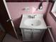 Pink tiled bathroom with vanity and sink at 2429 S Elm Ave, Sanford, FL 32771