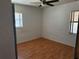 Simple bedroom with light wood flooring and two windows at 2429 S Elm Ave, Sanford, FL 32771