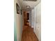 Long hallway with light wood flooring and built-in storage at 2429 S Elm Ave, Sanford, FL 32771