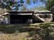 Rear view of house showcasing screened patio and yard at 2429 S Elm Ave, Sanford, FL 32771