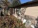 Side view of house exterior with fallen leaves and plywood at 2429 S Elm Ave, Sanford, FL 32771