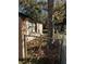 Side view of house exterior with chain link fence and fallen leaves at 2429 S Elm Ave, Sanford, FL 32771