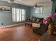 Living room with brown couch and wood floors at 2429 S Elm Ave, Sanford, FL 32771