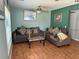 Living room with brown couches and wood floors at 2429 S Elm Ave, Sanford, FL 32771