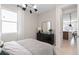 Cozy bedroom with dresser and view of the kitchen at 2436 Belle Haven Way, Davenport, FL 33896