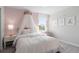 bedroom with a canopy bed and soft pink decor at 2436 Belle Haven Way, Davenport, FL 33896