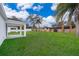 Large backyard with covered patio and a wooden privacy fence at 2706 Alamo Dr, Orlando, FL 32805