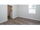 Bright bedroom with wood-look floors and an ensuite bathroom at 2706 Alamo Dr, Orlando, FL 32805